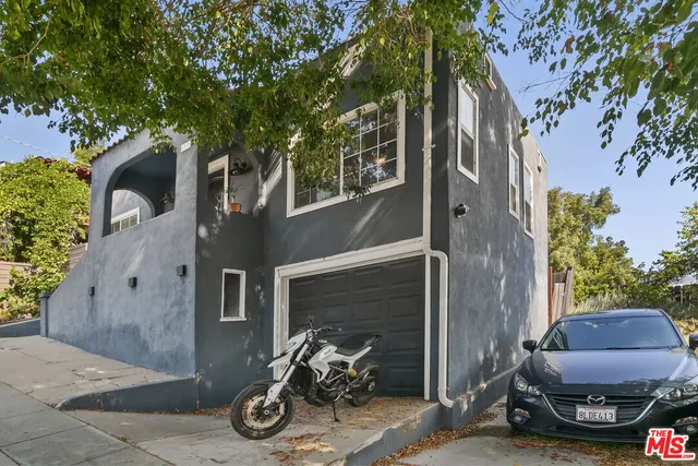 a view of a car park in front of house