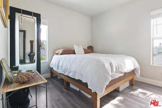 a bed sitting in a bedroom next to a window