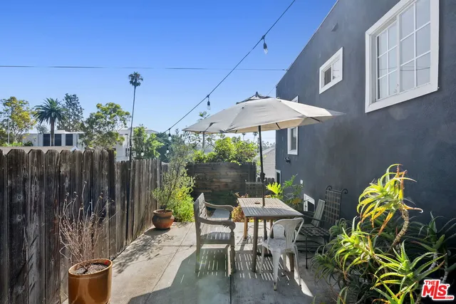 a view of a chairs and table in the patio