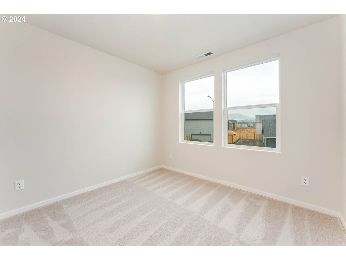 2654 U Street Springfield, OR 97477 - Photo 15 of 27 an empty room with wooden floor and windows