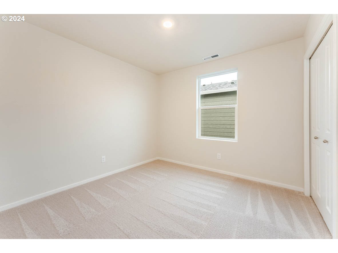 2654 U Street Springfield, OR 97477 - Photo 17 of 27 a view of an empty room with wooden floor and a window