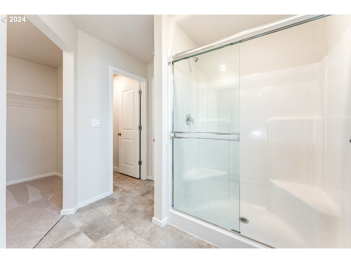 2654 U Street Springfield, OR 97477 - Photo 25 of 27 a bathroom with a glass shower door
