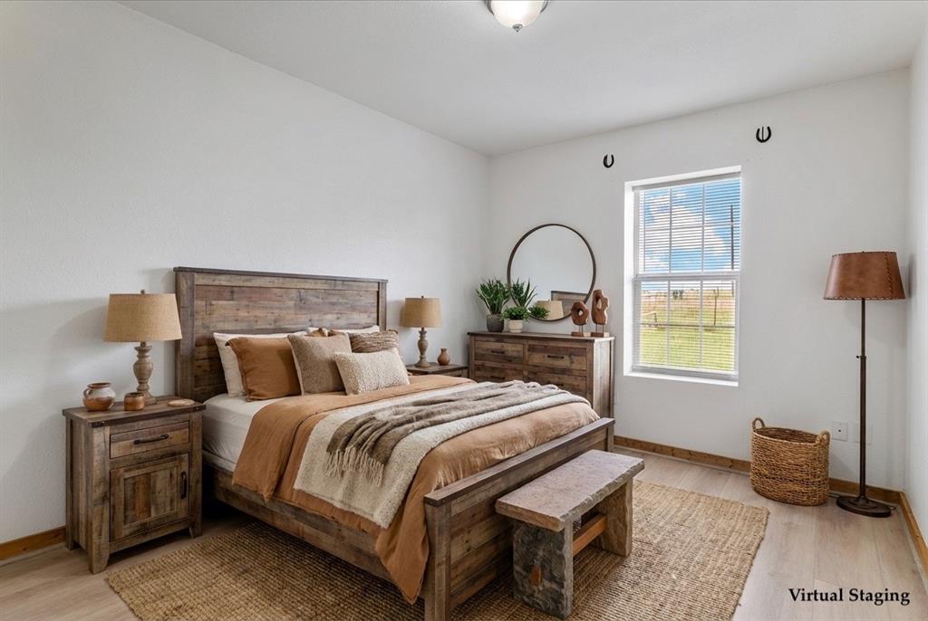 3300 Airport Road Tioga, TX 76271 - Photo 12 of 37 a bedroom with a bed and a potted plant on dresser