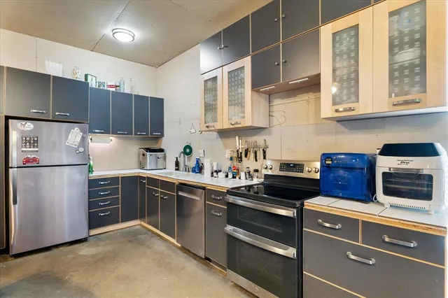 a kitchen with stainless steel appliances granite countertop a refrigerator sink and cabinets