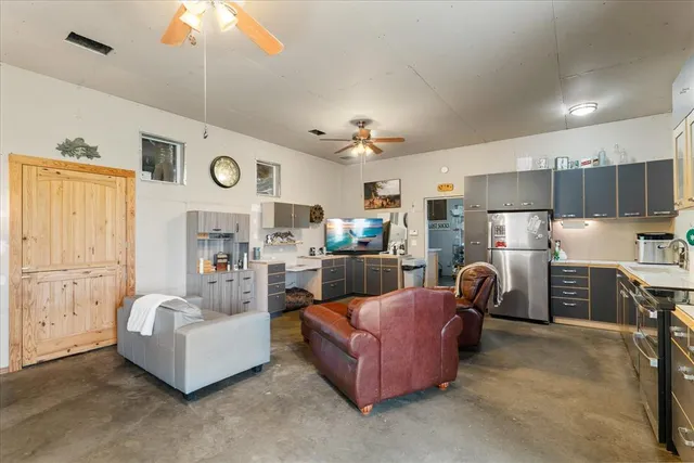 a living room with furniture and kitchen view
