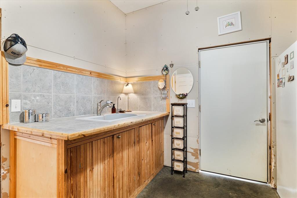 3300 Airport Road Tioga, TX 76271 - Photo 24 of 37 a bathroom with a sink and a mirror