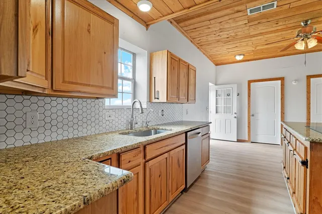 a kitchen with sink cabinets and wooden floor