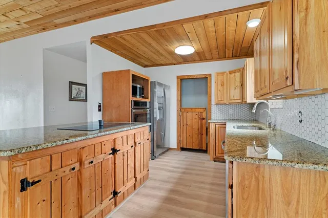 a kitchen with stainless steel appliances granite countertop a sink and cabinets