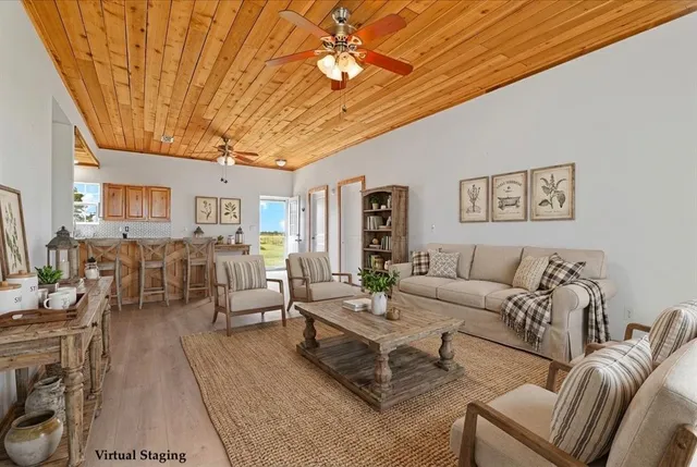 a living room with furniture wooden floor and wall painting