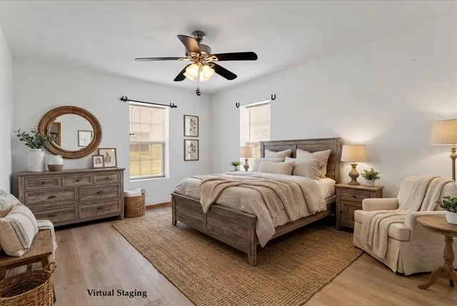 a bedroom with a bed a mirror and a chandelier