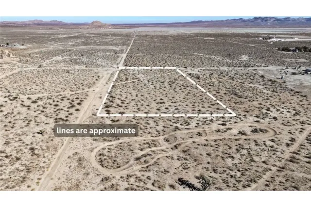 a view of a dry yard with mountains