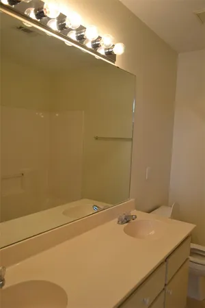 a bathroom with a sink and vanity