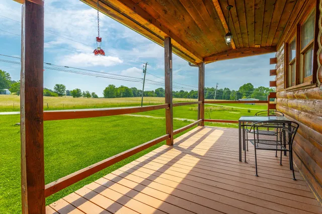 a view of a patio with a table and chairs under an umbrella