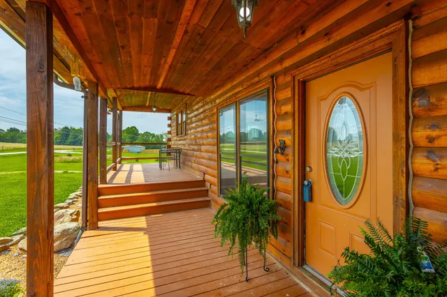 a living room with furniture or wooden floor and windows