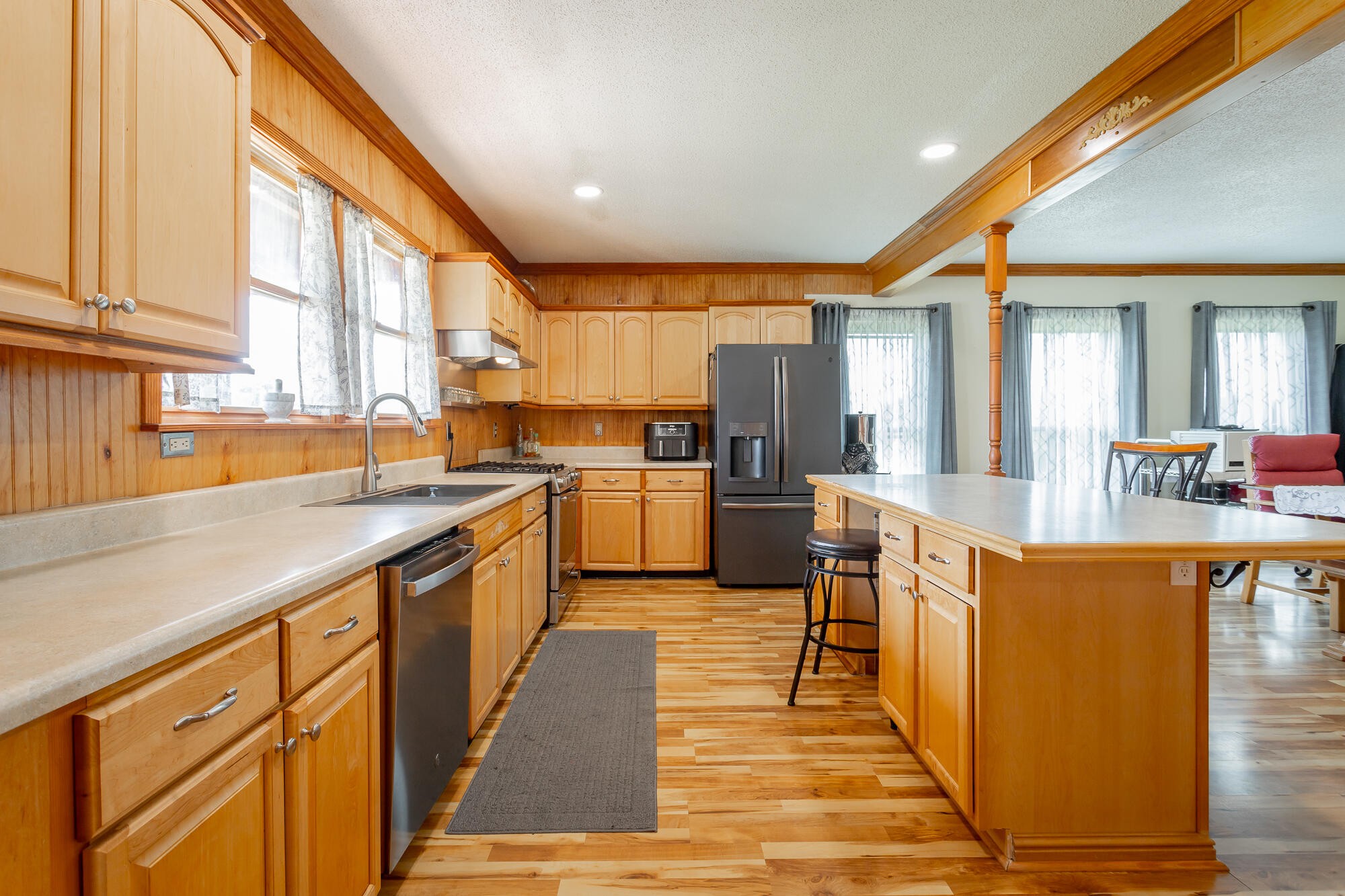 2195 Myers Road Pikeville, TN 37367 - Photo 32 of 100 a kitchen with stainless steel appliances granite countertop a refrigerator a sink dishwasher a dining table and chairs with wooden floor