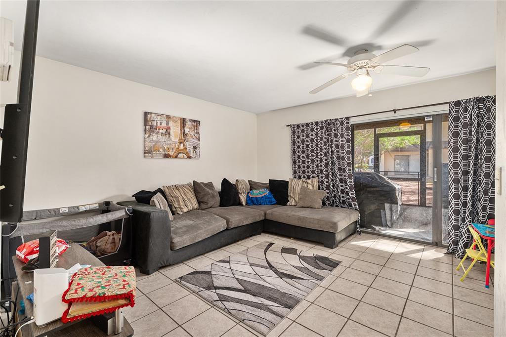 2735 Southwest 35th Place, Unit 801 Gainesville, FL 32608 - Photo 2 of 35 a living room with furniture and a chandelier