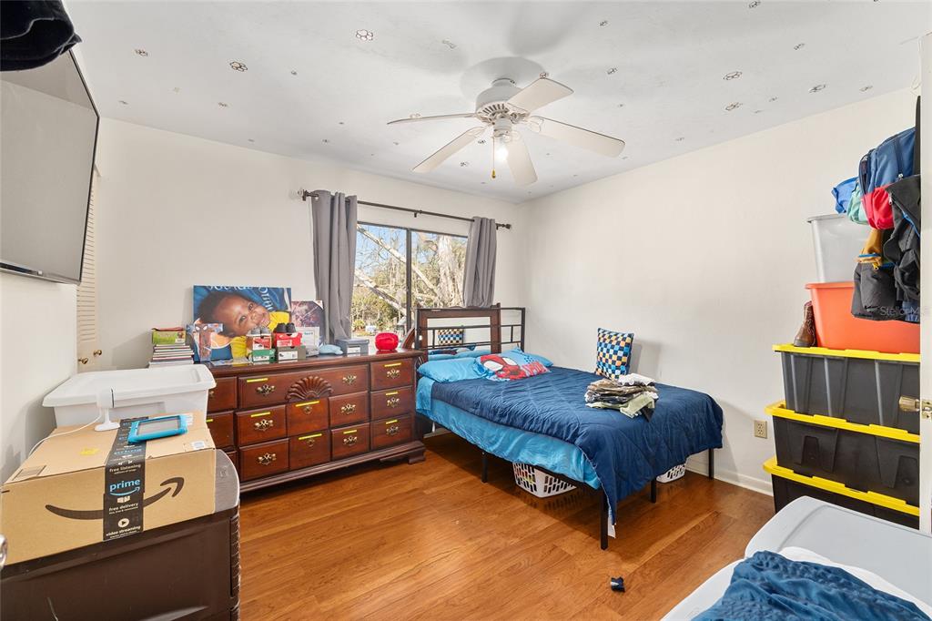 2735 Southwest 35th Place, Unit 801 Gainesville, FL 32608 - Photo 21 of 35 a bed room with a bed and a dresser