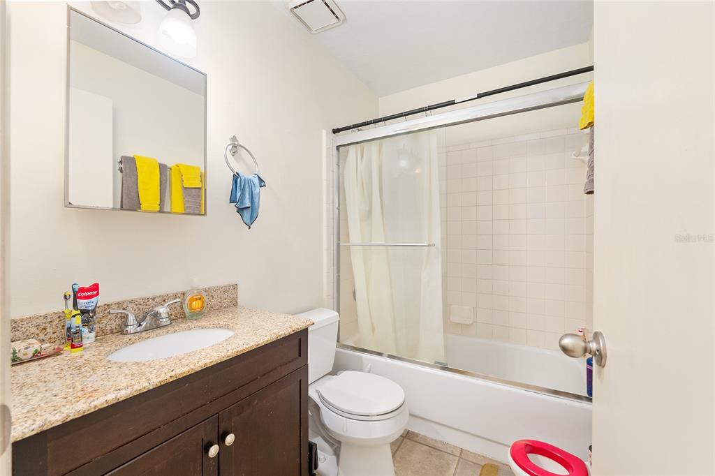2735 Southwest 35th Place, Unit 801 Gainesville, FL 32608 - Photo 23 of 35 a bathroom with a granite countertop sink toilet and shower