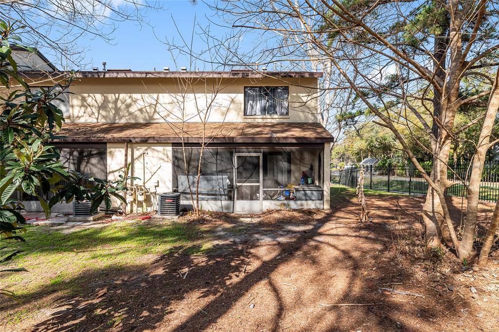 2735 Southwest 35th Place, Unit 801 Gainesville, FL 32608 - Photo 29 of 35 a view of a house with backyard porch and sitting area