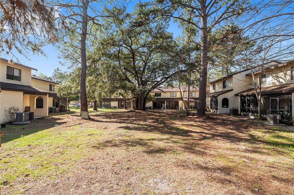 2735 Southwest 35th Place, Unit 801 Gainesville, FL 32608 - Photo 30 of 35 a view of a yard with a tree