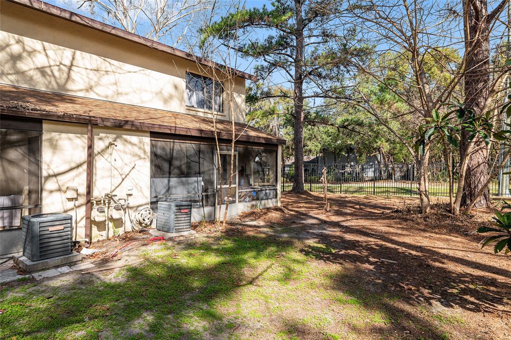 2735 Southwest 35th Place, Unit 801 Gainesville, FL 32608 - Photo 31 of 35 a view of a house with backyard porch and sitting area