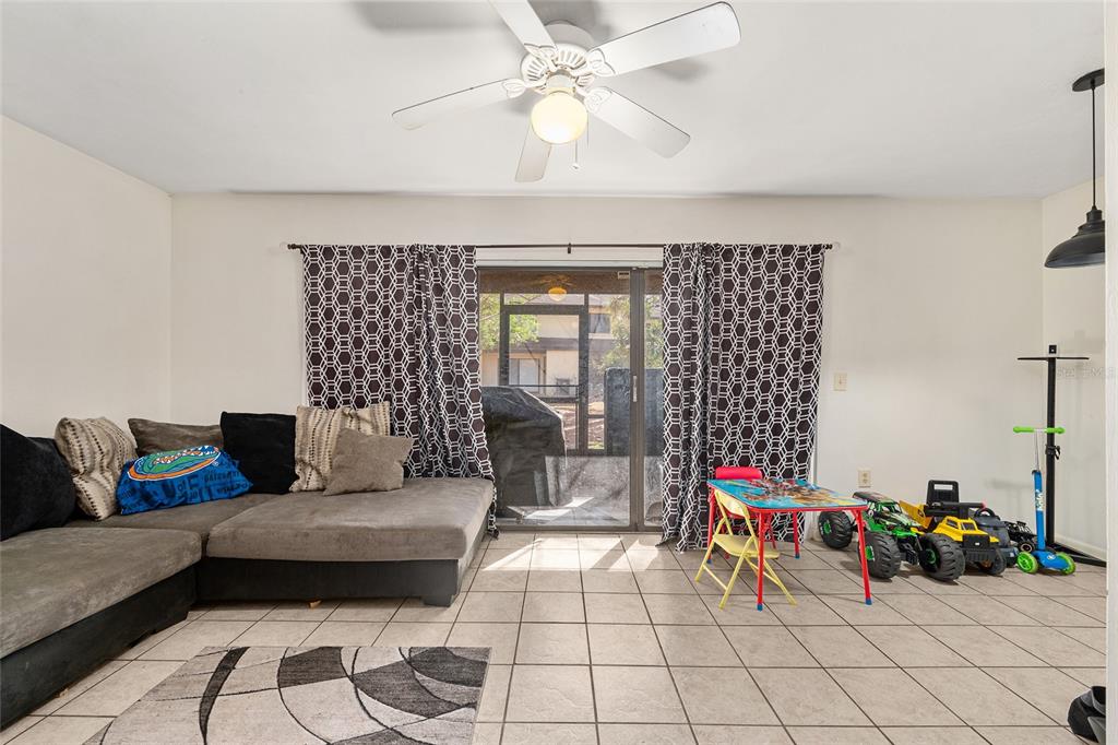 2735 Southwest 35th Place, Unit 801 Gainesville, FL 32608 - Photo 4 of 35 a living room with furniture and a chandelier