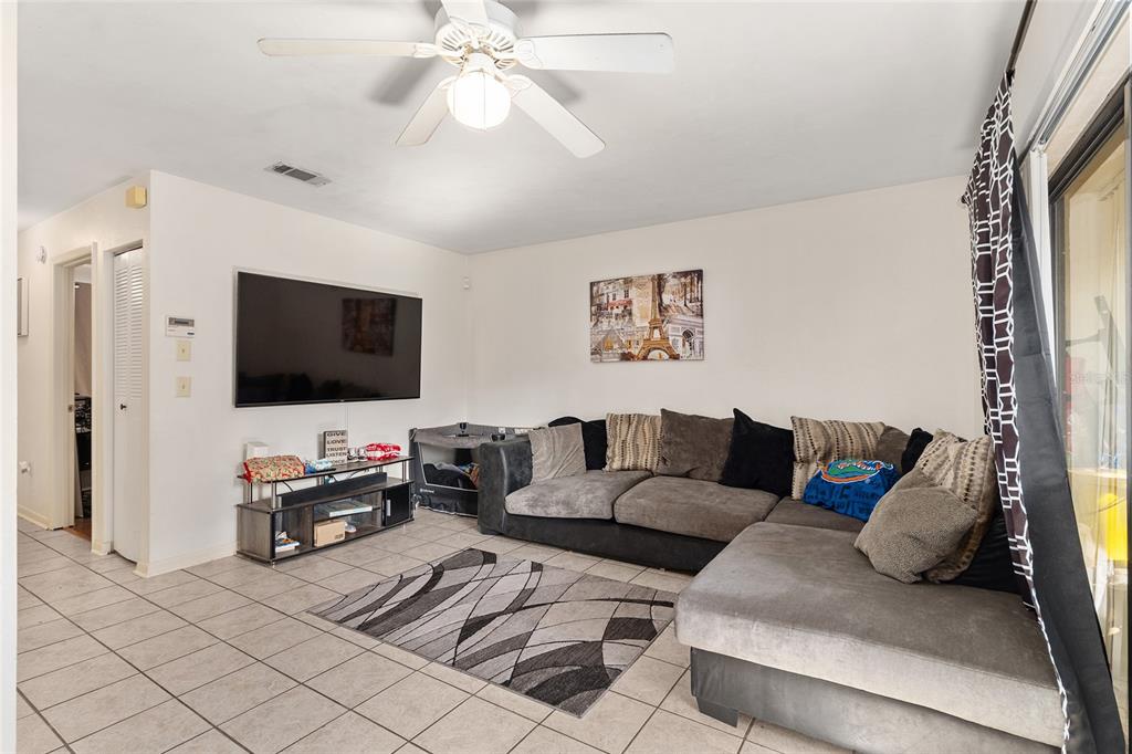 2735 Southwest 35th Place, Unit 801 Gainesville, FL 32608 - Photo 5 of 35 a living room with furniture and a flat screen tv
