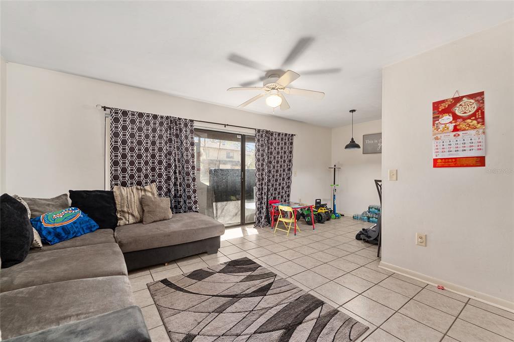 2735 Southwest 35th Place, Unit 801 Gainesville, FL 32608 - Photo 6 of 35 a living room with furniture and wooden floor