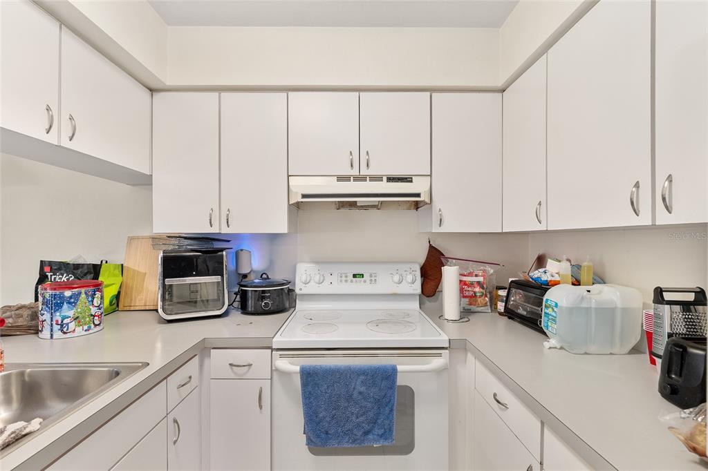 2735 Southwest 35th Place, Unit 801 Gainesville, FL 32608 - Photo 9 of 35 a kitchen with a sink a stove and cabinets