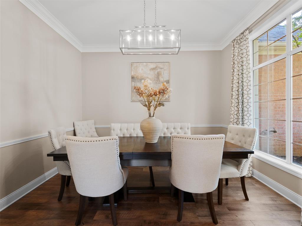 1103 Marigold Lane Longview, TX 75604 - Photo 5 of 34 a dining room with furniture a chandelier and wooden floor