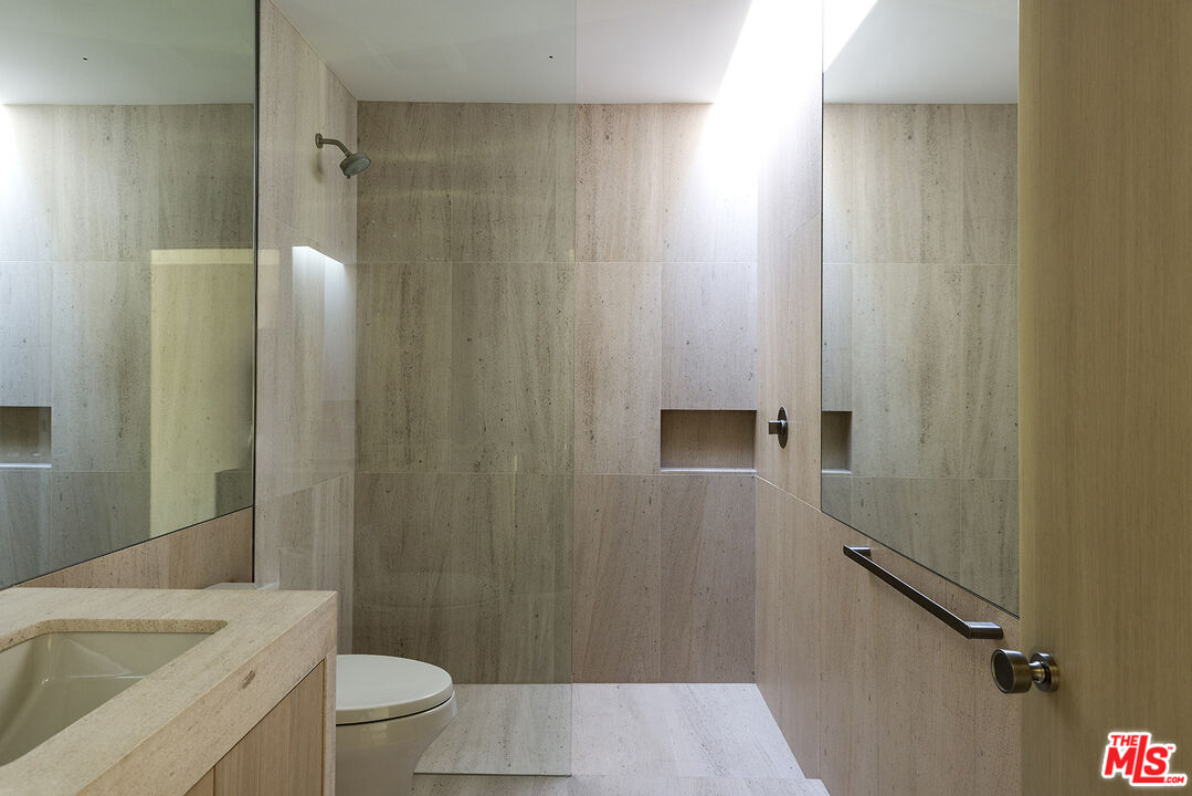 40281 Sand Dune Road Rancho Mirage, CA 92270 - Photo 25 of 39 a bathroom with a sink a toilet and shower