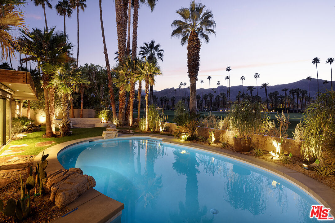 40281 Sand Dune Road Rancho Mirage, CA 92270 - Photo 34 of 39 a view of a swimming pool with a table and chairs