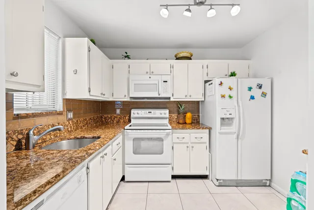 a kitchen with refrigerator a stove a sink and dishwasher
