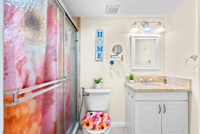 a bathroom with a sink mirror and vanity