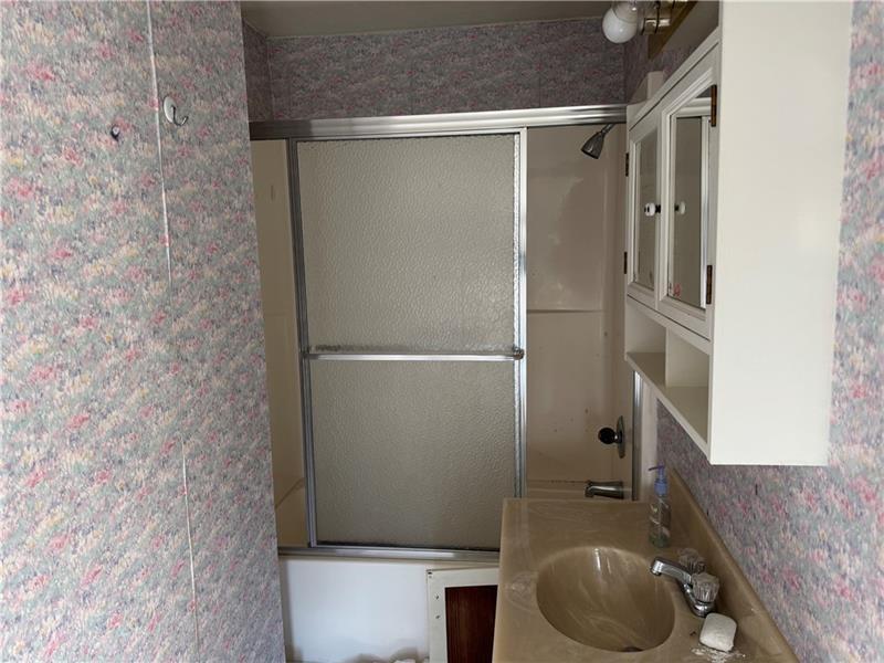 2822 Main Street Beallsville, PA 15313 - Photo 11 of 11 a bathroom with a granite countertop bathtub shower sink and toilet