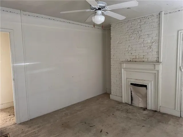 a view of a livingroom with an empty space and a fireplace
