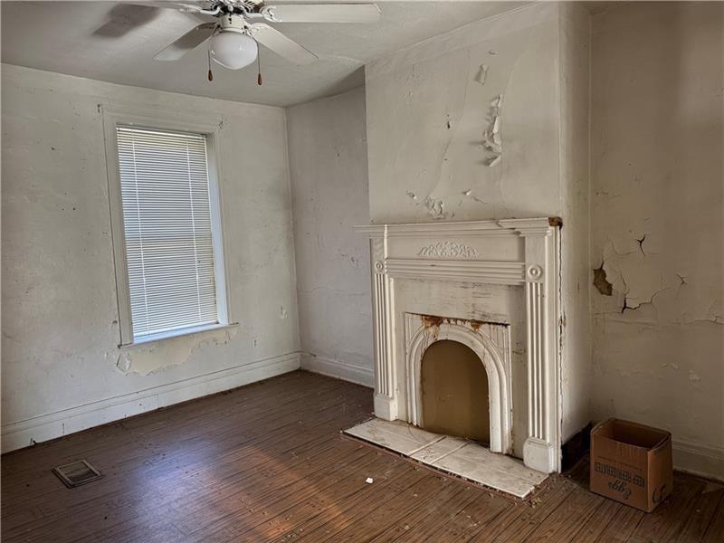 2822 Main Street Beallsville, PA 15313 - Photo 5 of 11 a view of a livingroom with a fireplace wooden floor and a chandelier