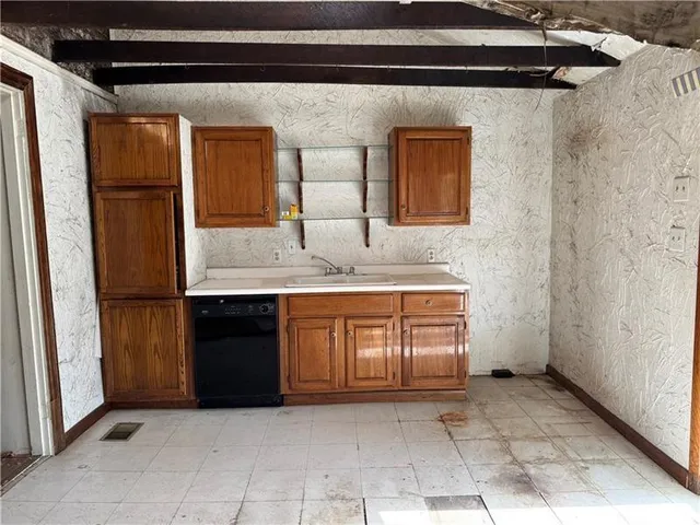 a bathroom with a granite countertop sink and washing machine
