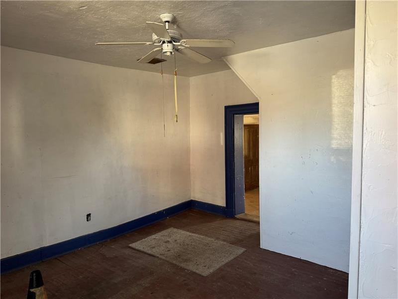 2822 Main Street Beallsville, PA 15313 - Photo 7 of 11 an empty room with a ceiling fan and a fan