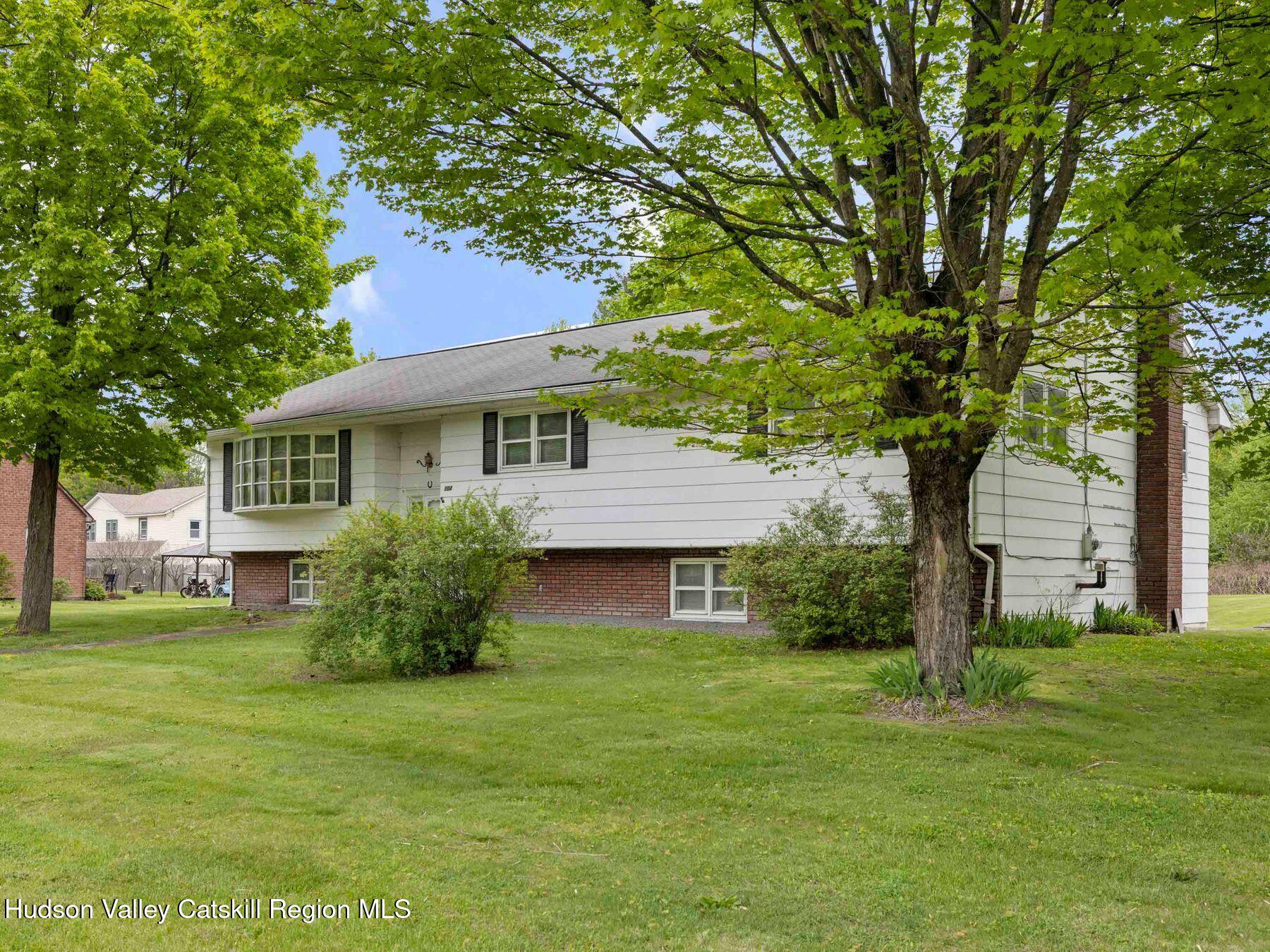 104 New Paltz Road Highland, NY 12528 - Photo 1 of 43 a front view of a house with a garden