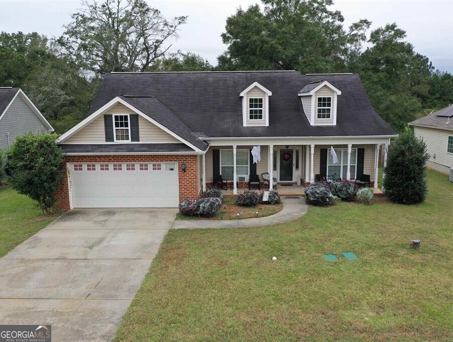 a front view of a house with yard and green space