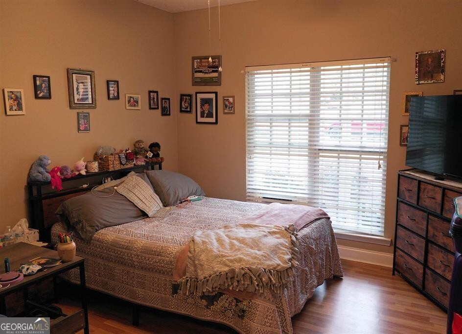 201 Boulder Creek Road Kathleen, GA 31047 - Photo 14 of 21 a bedroom with a bed and a flat screen tv