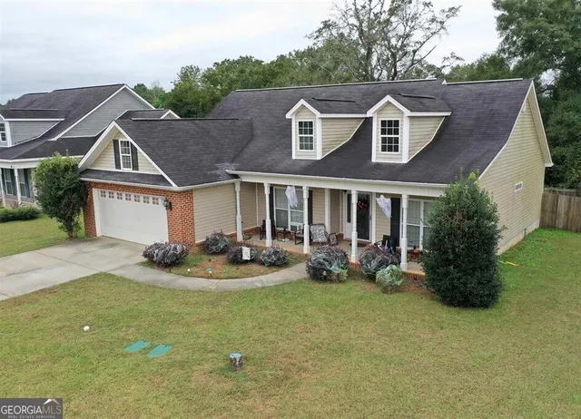 a front view of a house with garden and porch