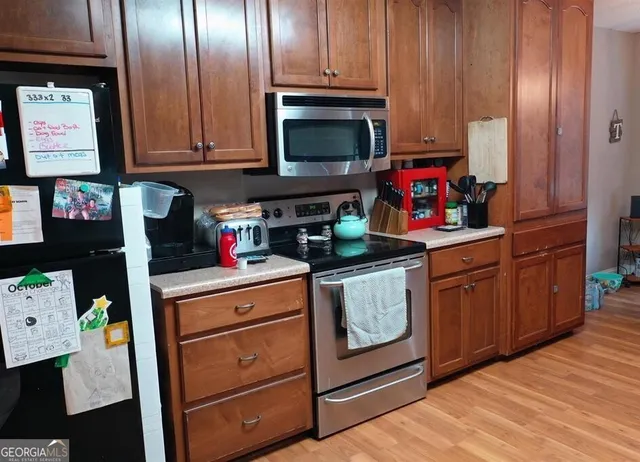 a kitchen with stainless steel appliances granite countertop a stove and cabinets