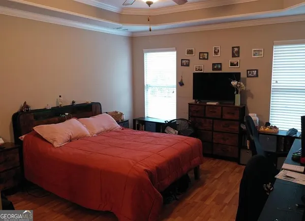 a bedroom with a bed and a flat screen tv