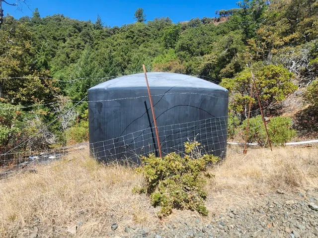 a wooden fence with trees in the background