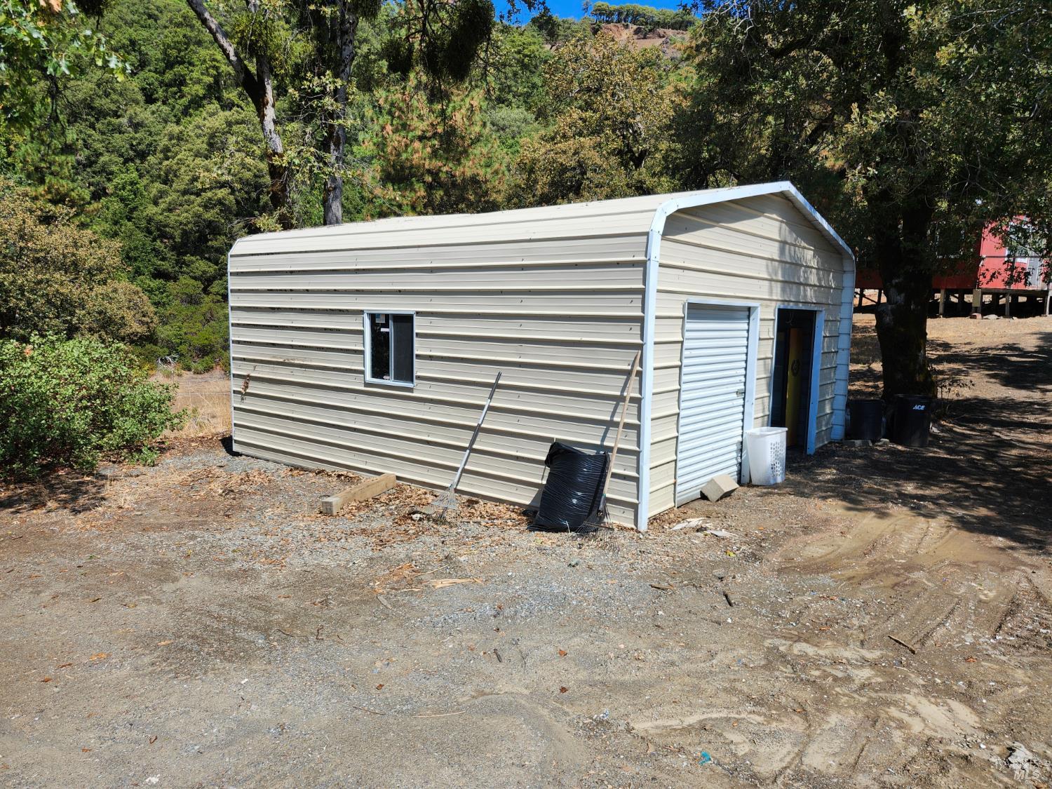 5635 Iron Peak Road Laytonville, CA 95454 - Photo 4 of 15 a view of a house with a yard and garage