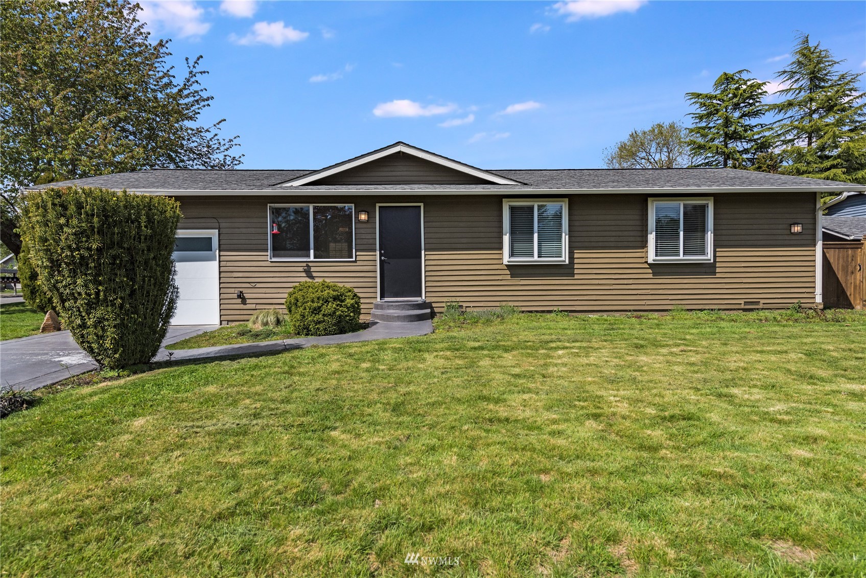 1303 227th Place Southwest Bothell, WA 98021 - Photo 1 of 21 a front view of a house with garden