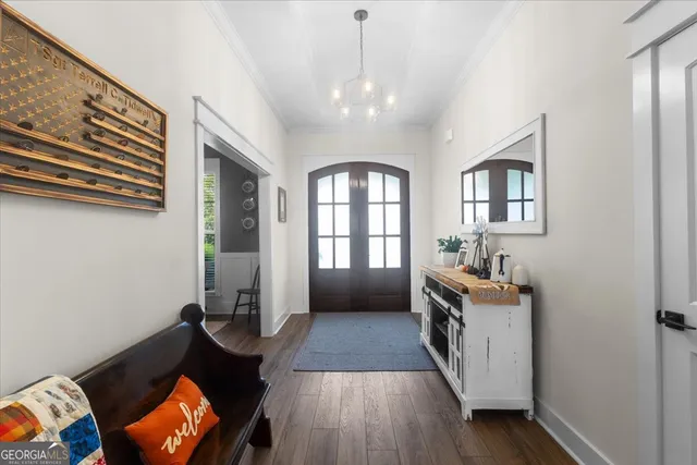 a view of a hallway with wooden floor