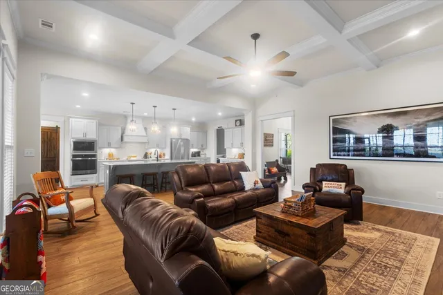 a bedroom with a bed a desk and chair with windows